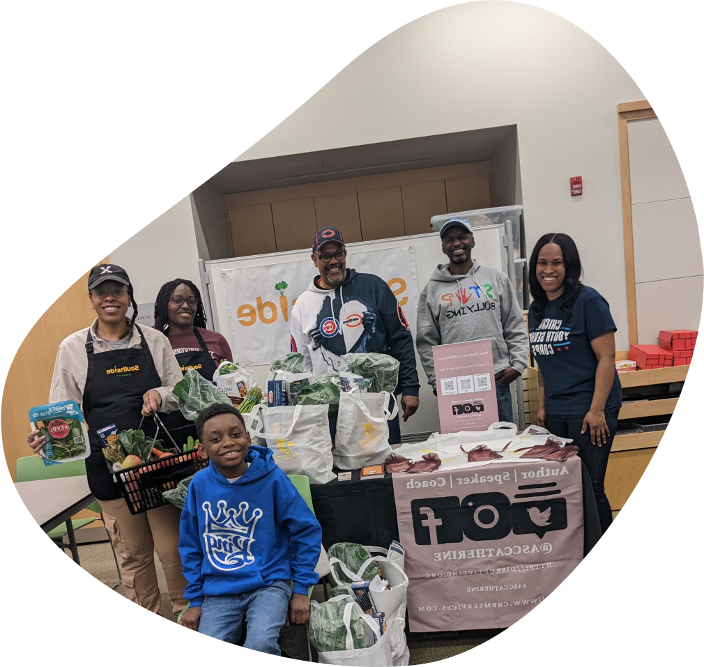 Founder, Catherine McNeil, with volunteers and representatives from Southside Market in Chicago holding bags of nutritious groceries to distribute.